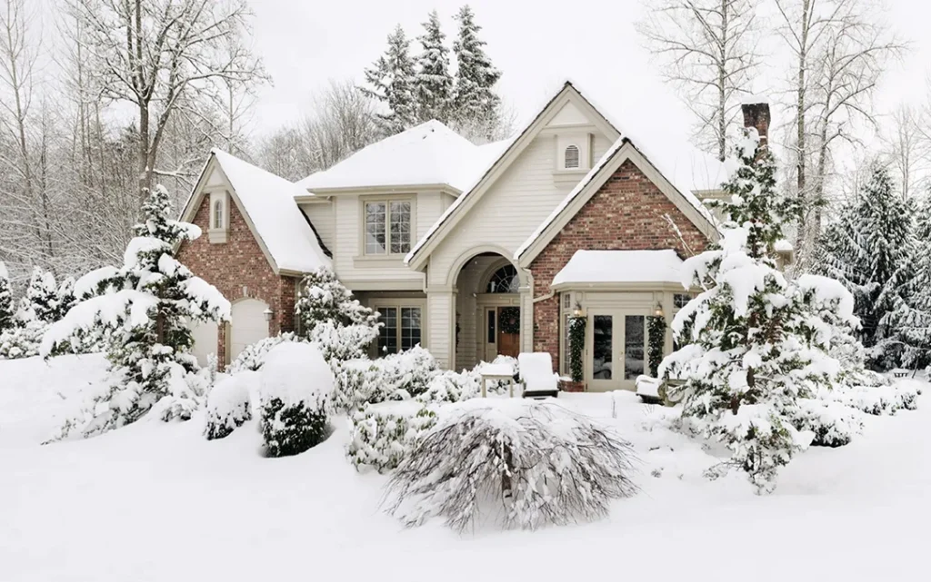 Snow covered home in Maple Grove MN during extreme cold weather with furnace running