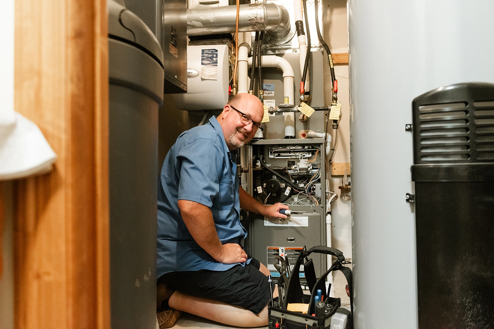Dave Brinkhaus, owner of Brinks Heating & Air, servicing residential furnace with tune-up