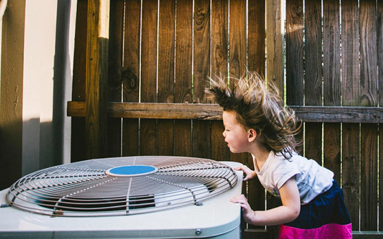 Girl enjoys are blowing from professionally installed AC