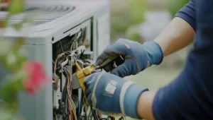 Man doing DIY AC repair at his Minnesota home