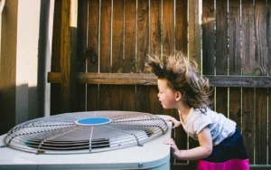 Girl enjoys are blowing from professionally installed AC